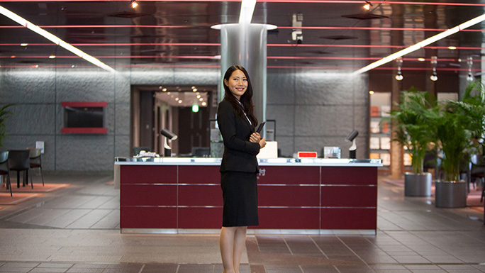 Hotel manager holding a tablet in the reception area